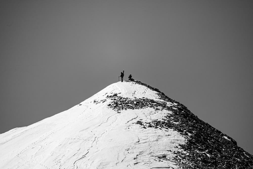 person standing on snow covered mountain
