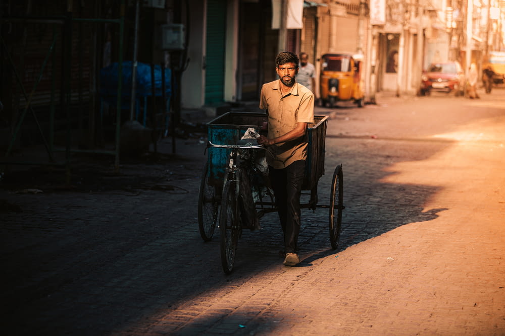 man in brown dress shirt riding on bicycle during daytime