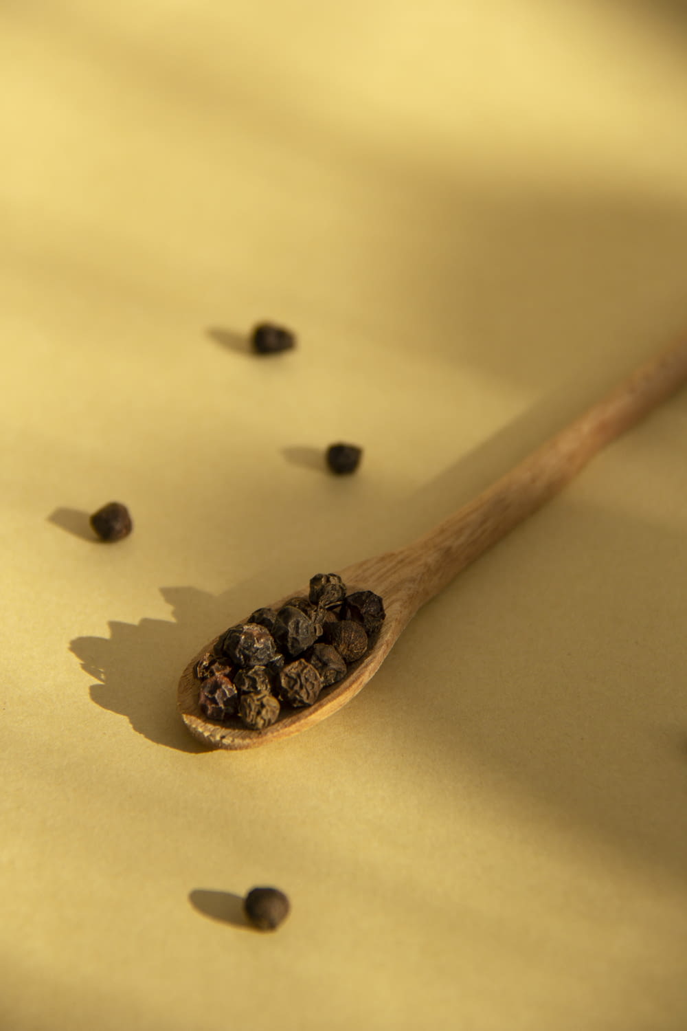 brown wooden spoon with black beans