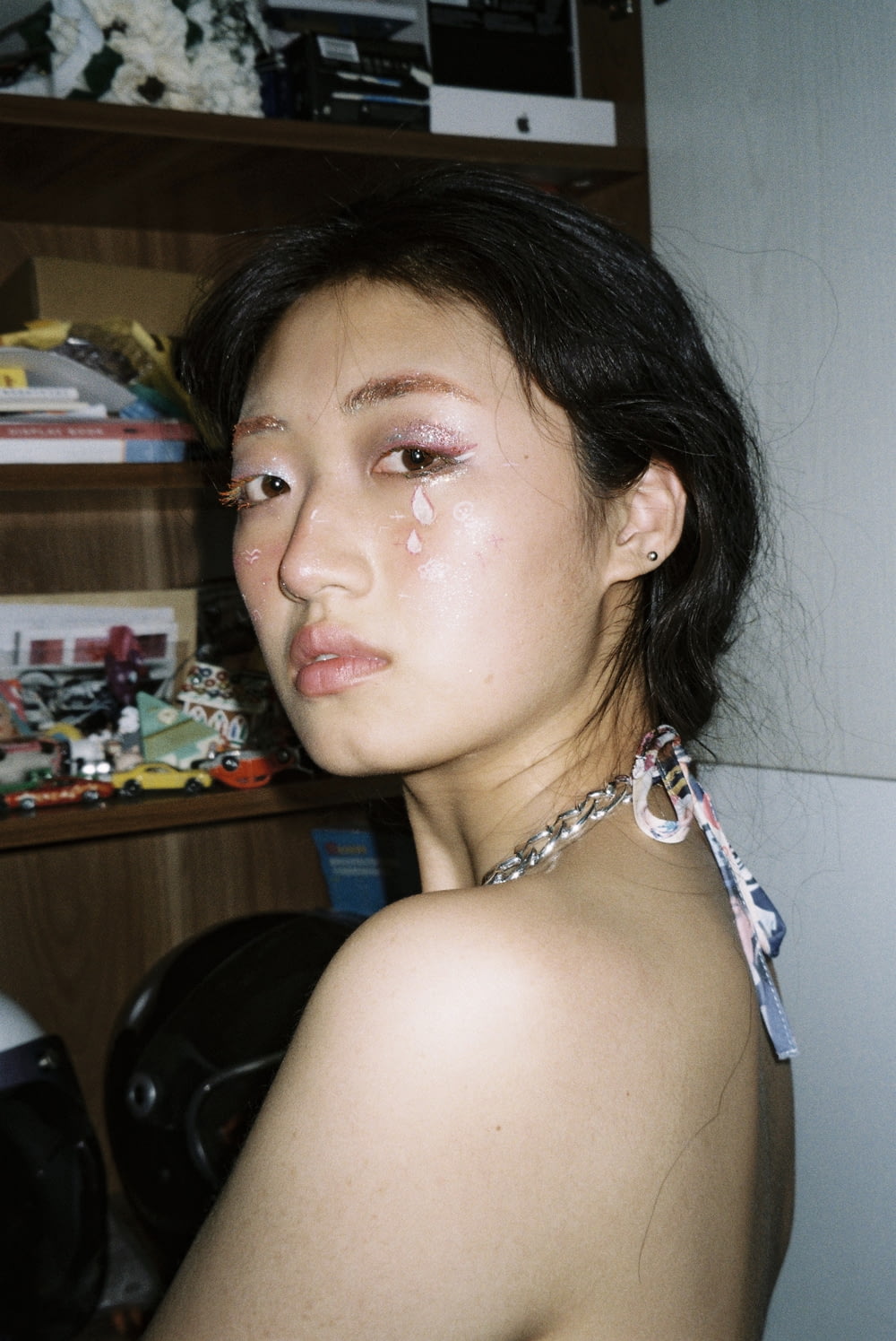 a young woman with a teary face standing in a room