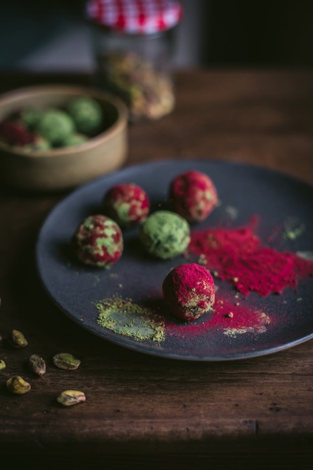 green and red fruits on blue ceramic plate