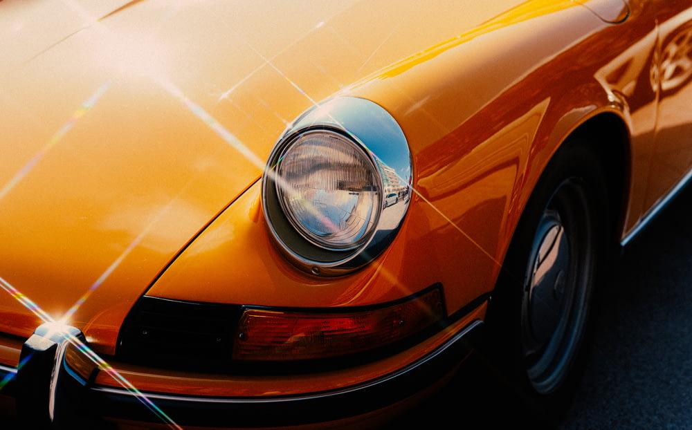 orange car with chrome headlight