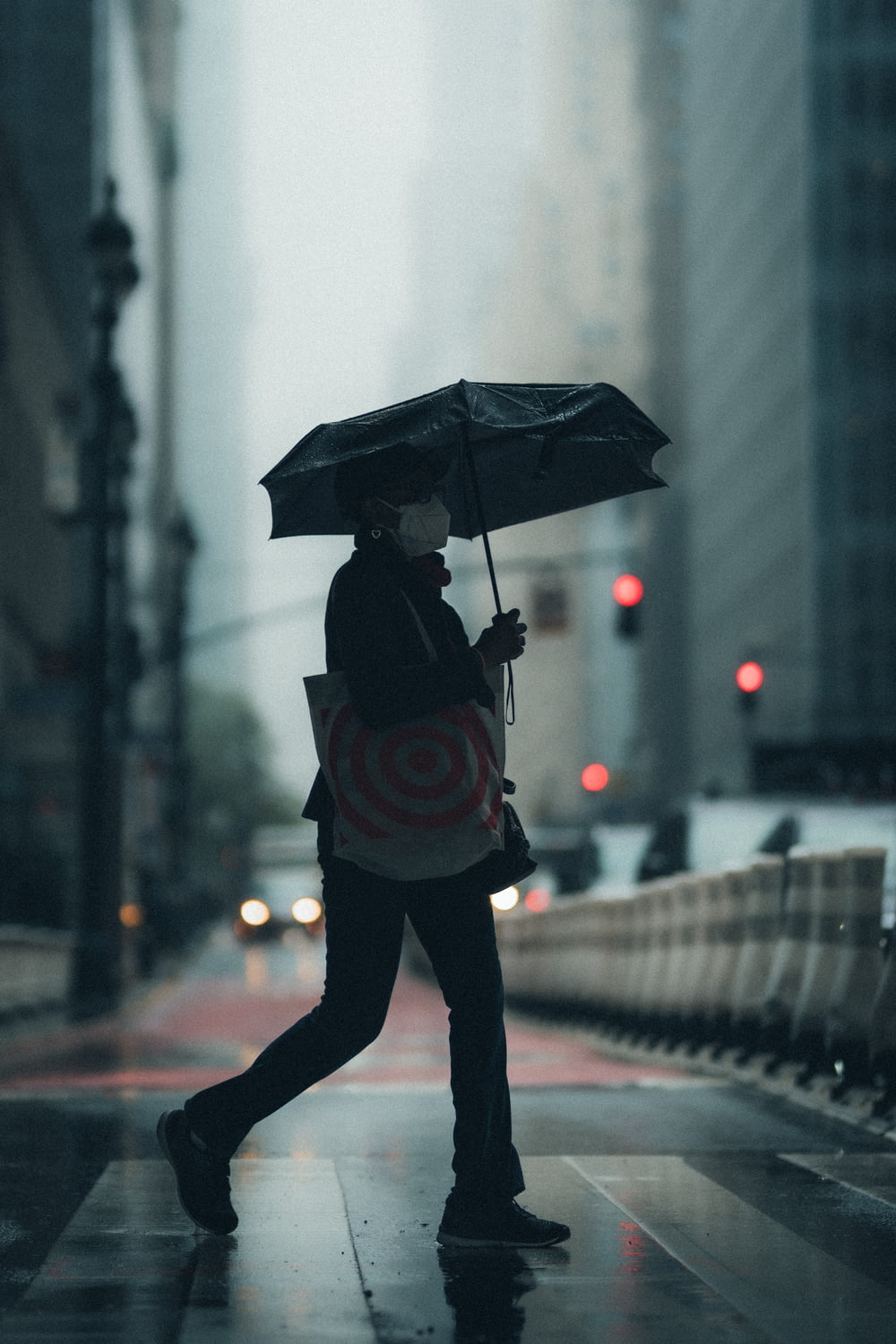 person in black jacket holding umbrella