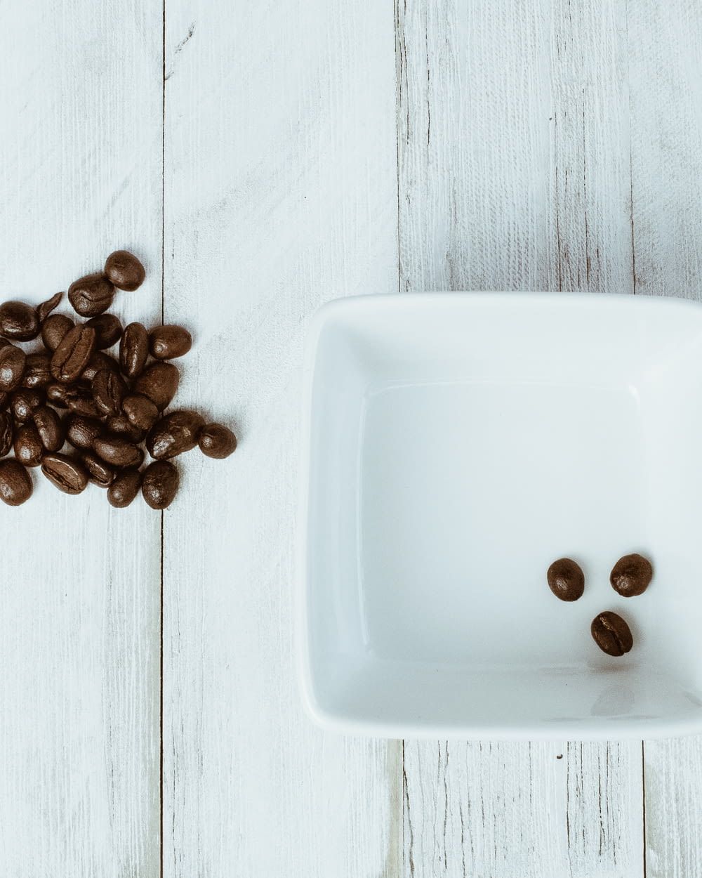 brown coffee beans on white ceramic rectangular tray