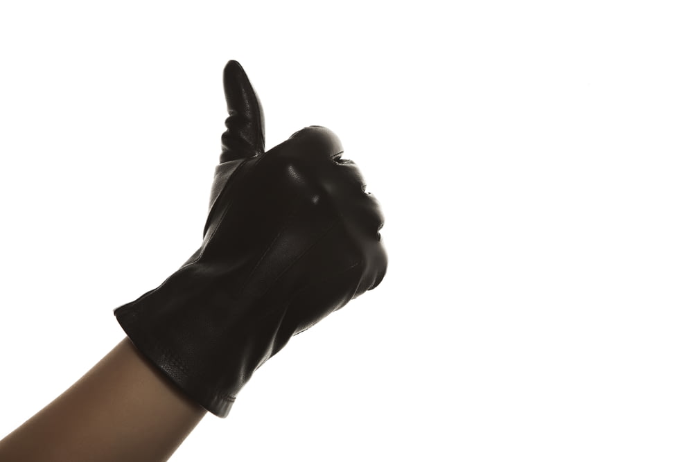 person wearing black leather gloves