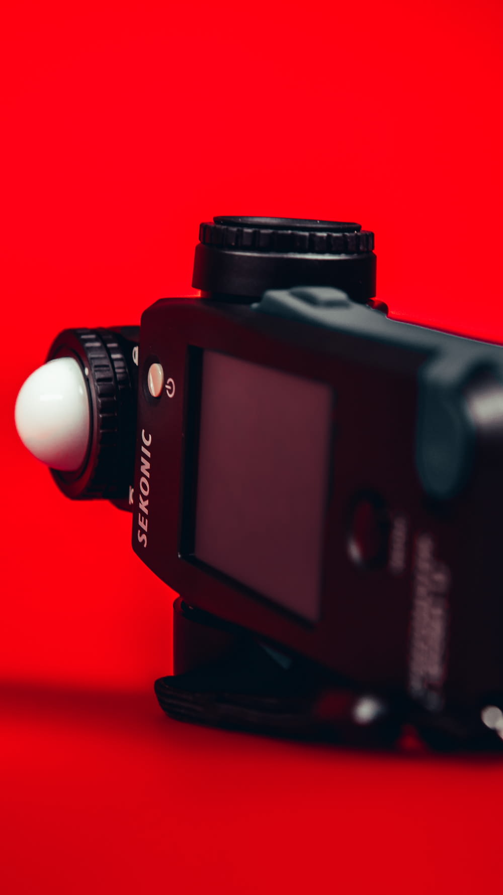 black canon dslr camera on red surface