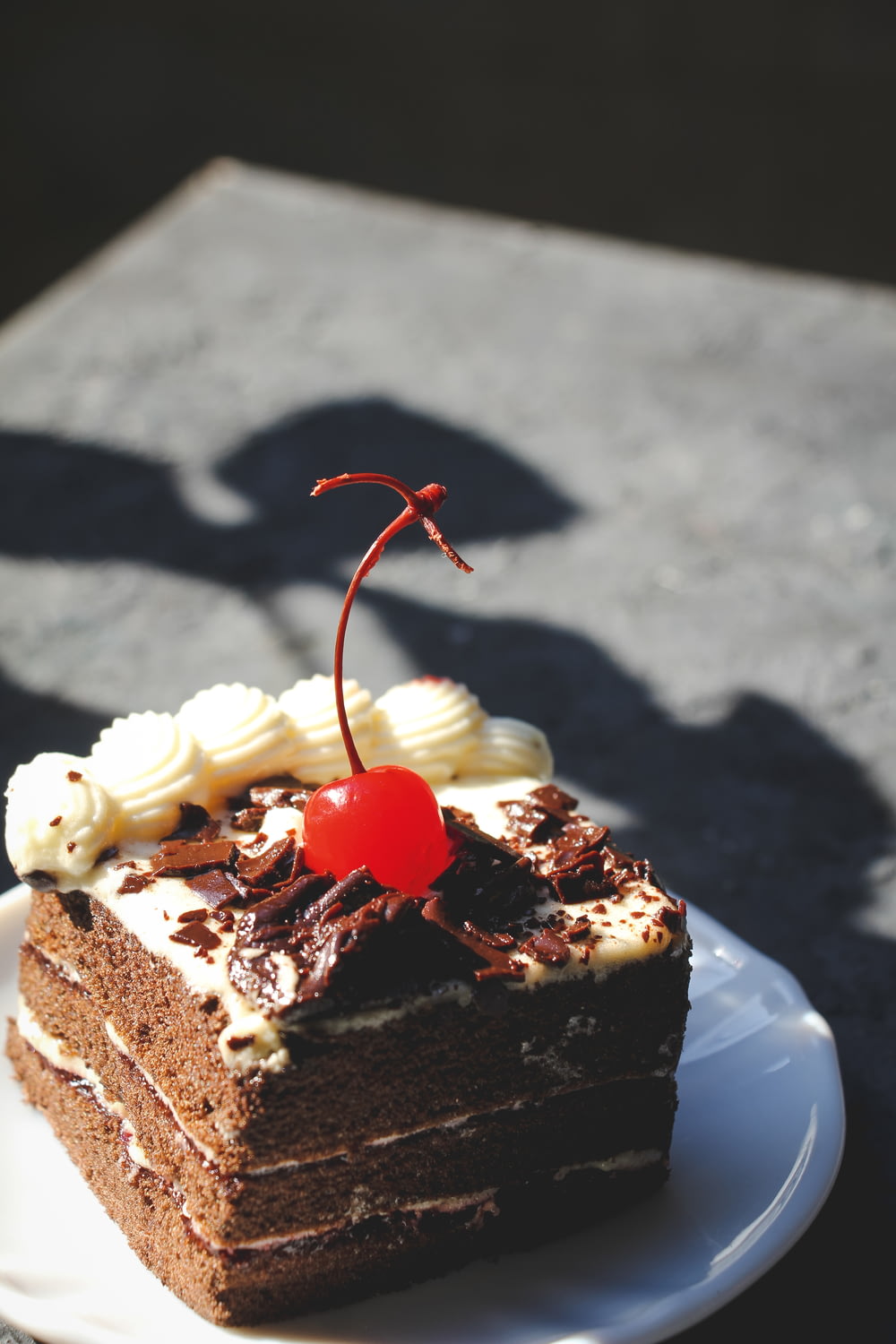 white and brown cake with red ribbon on top