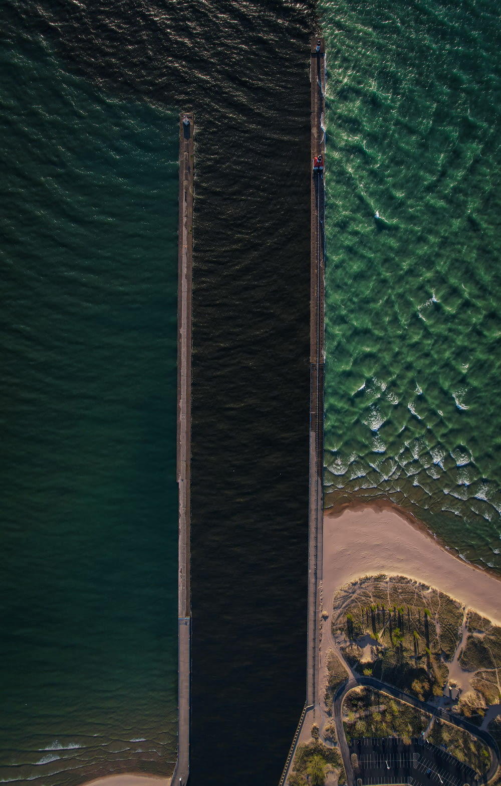 aerial view of sea and brown wooden dock during daytime