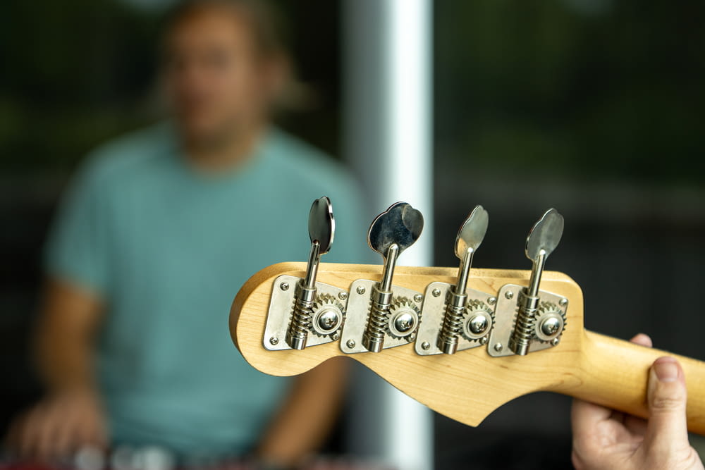 a person holding a guitar with spoons and forks on it