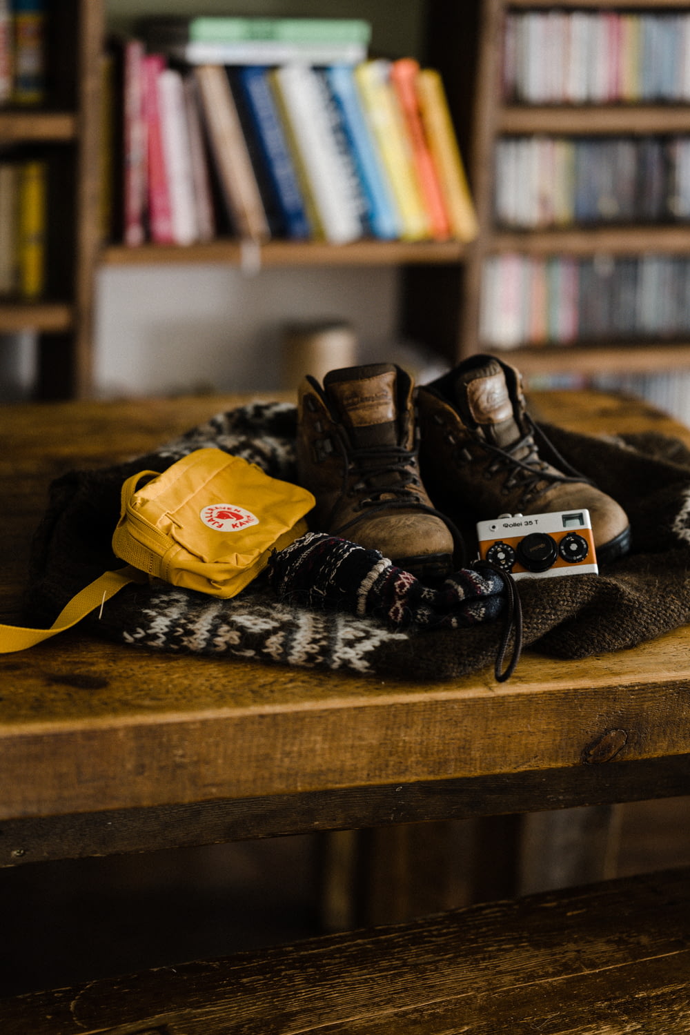 black and yellow lace up boots on brown wooden table