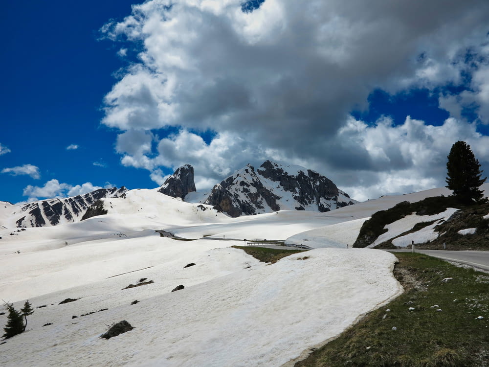 snow covered mountain under blue sky and white clouds during daytime