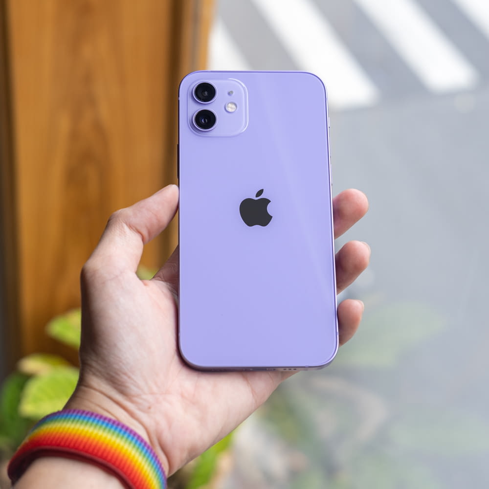 person holding blue iphone 5 c