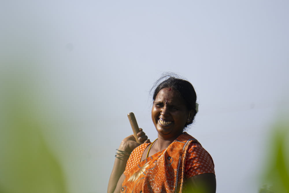 woman in orange and green sari