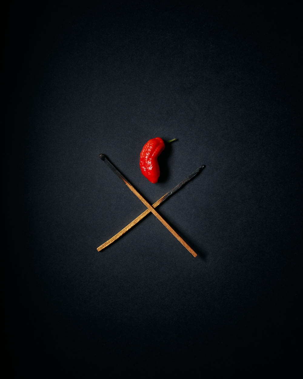 red strawberry on black surface