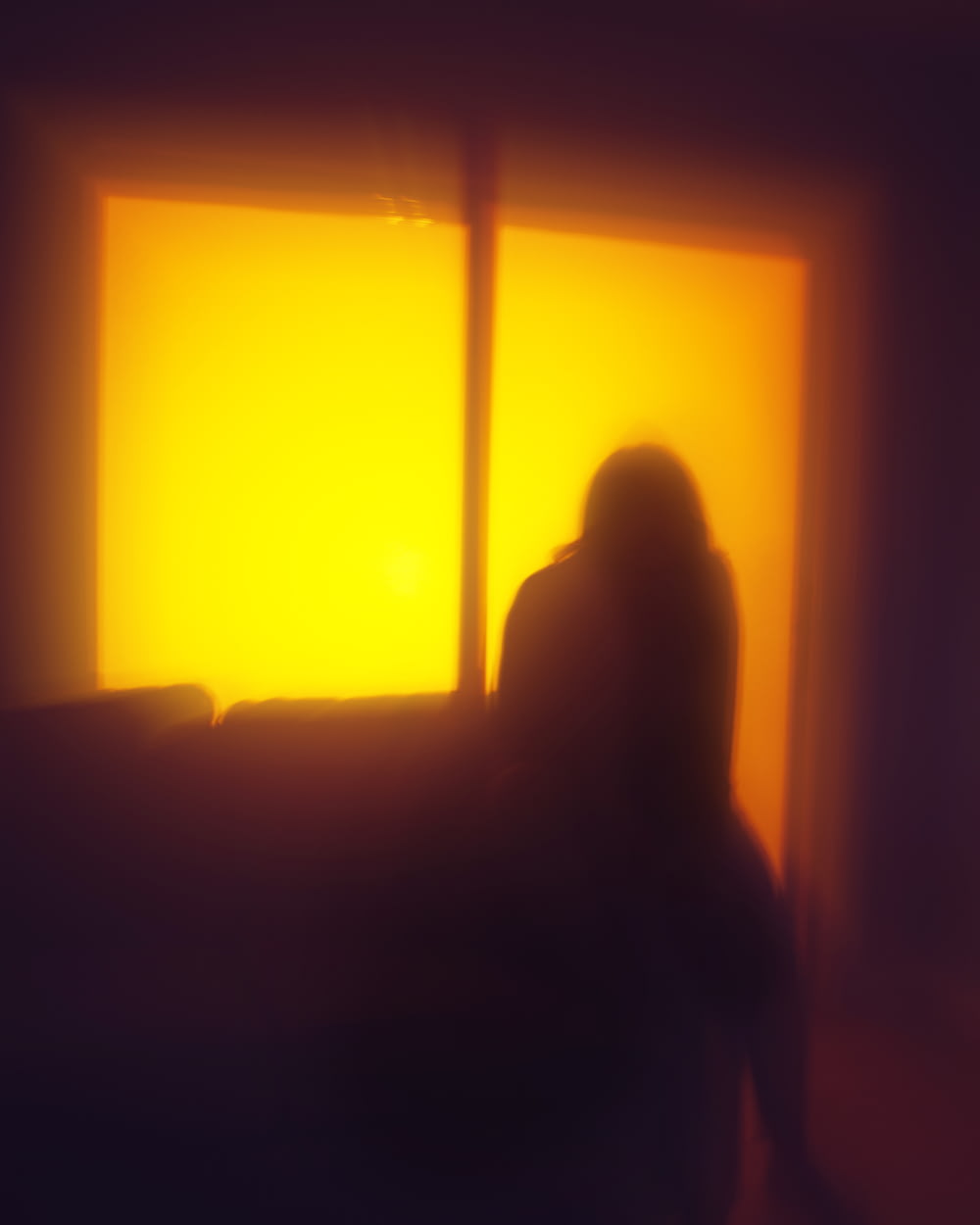 silhouette of person sitting on couch