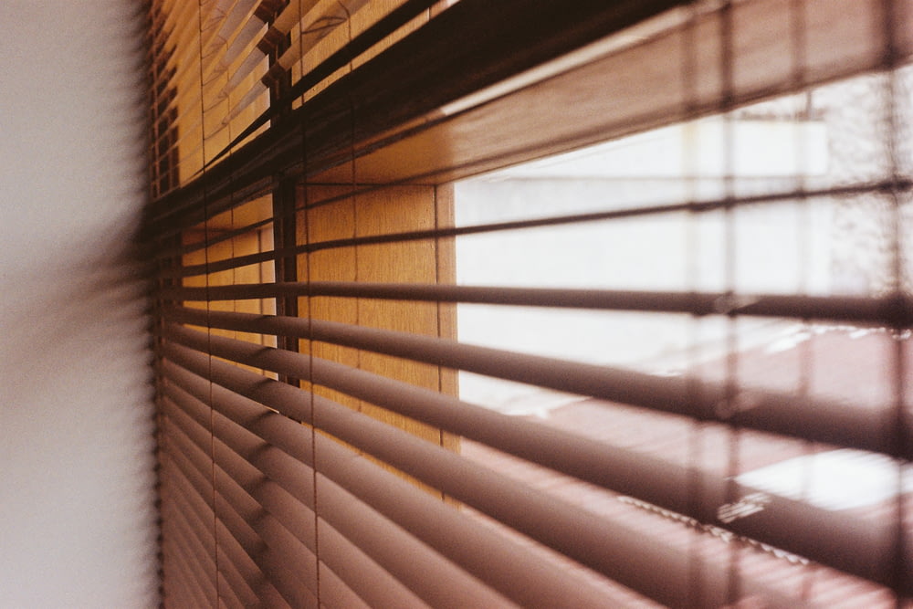 brown window blinds during daytime