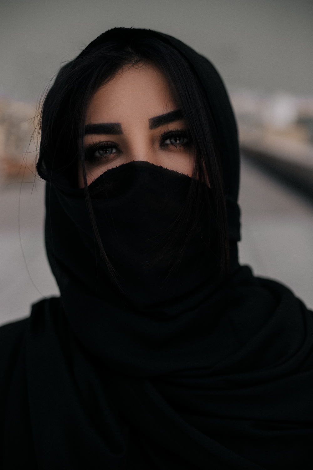 woman in black hijab taking selfie