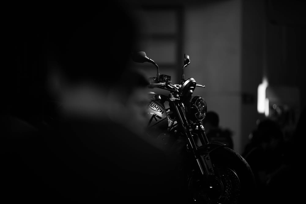 grayscale photo of motorcycle in a dark room