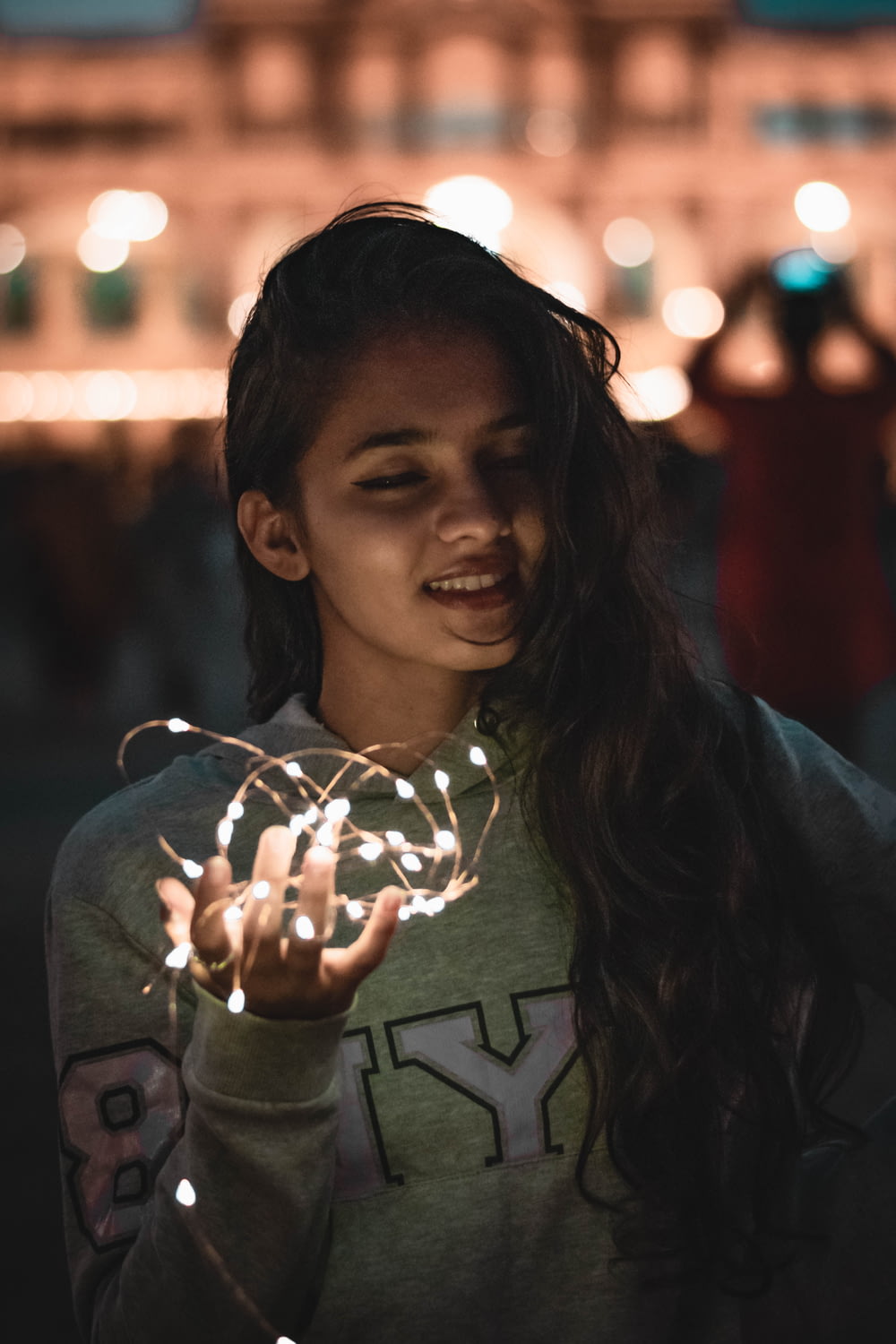 a young girl holding a sparkle ball in her hands