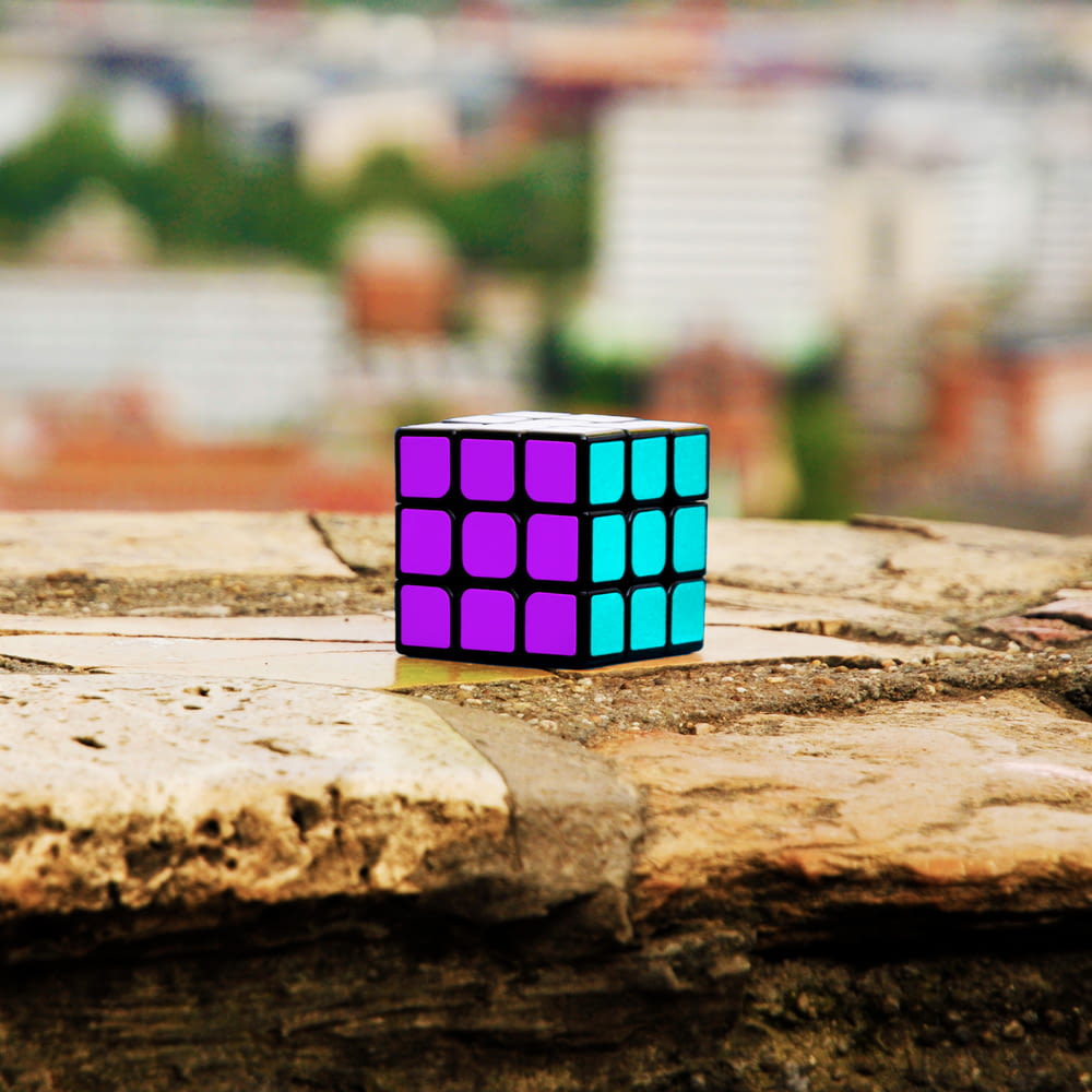 a rubik cube sitting on top of a piece of wood