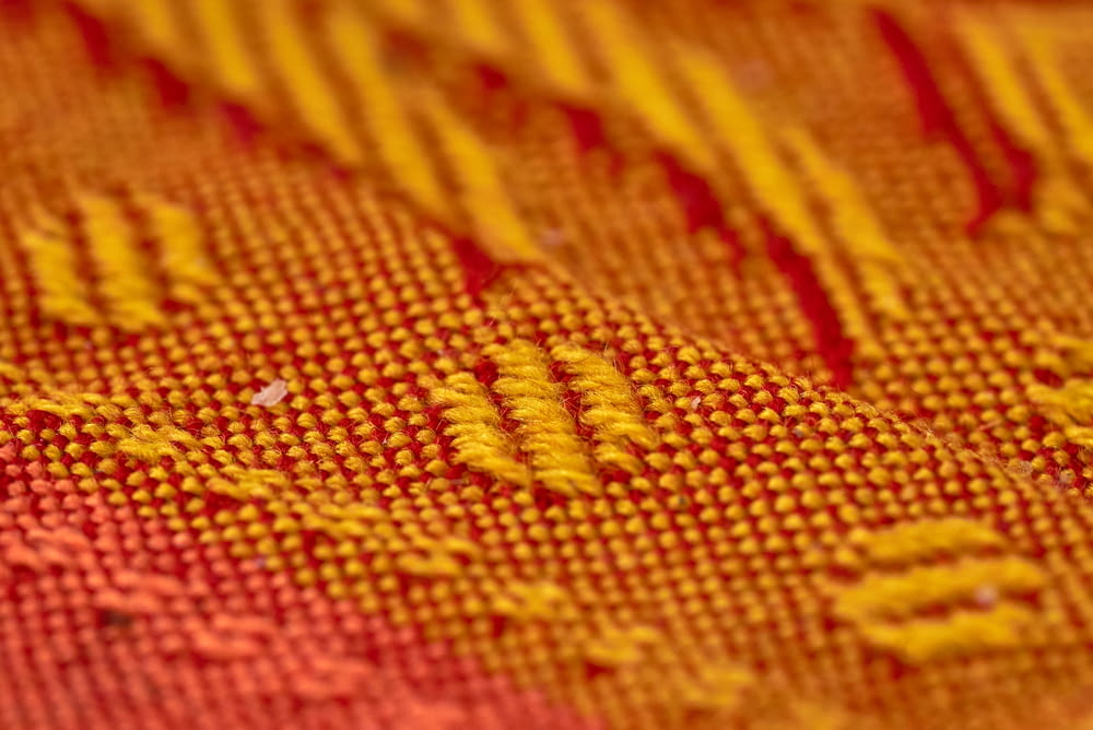red and yellow knit textile