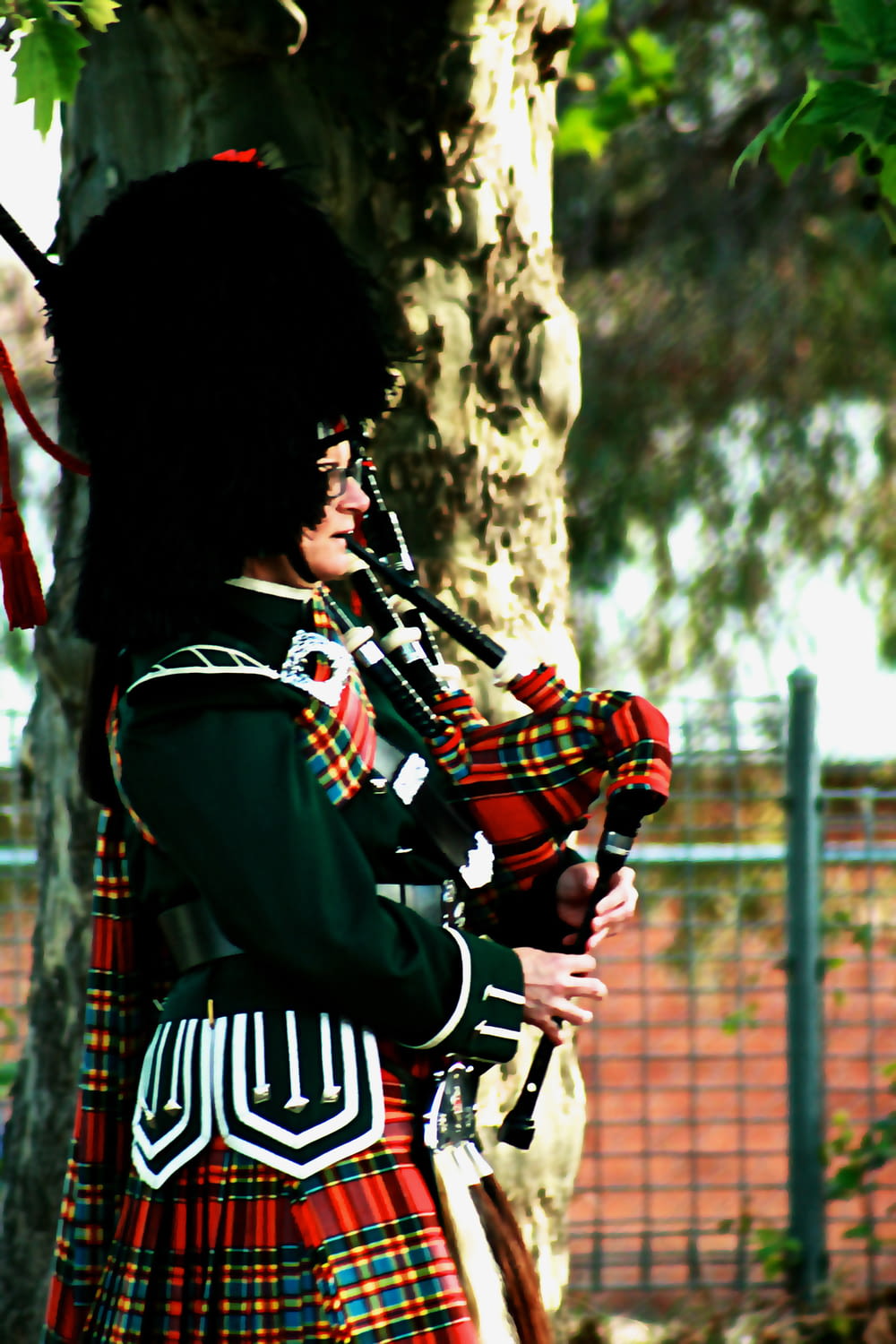a man in a kilt playing a bagpipe