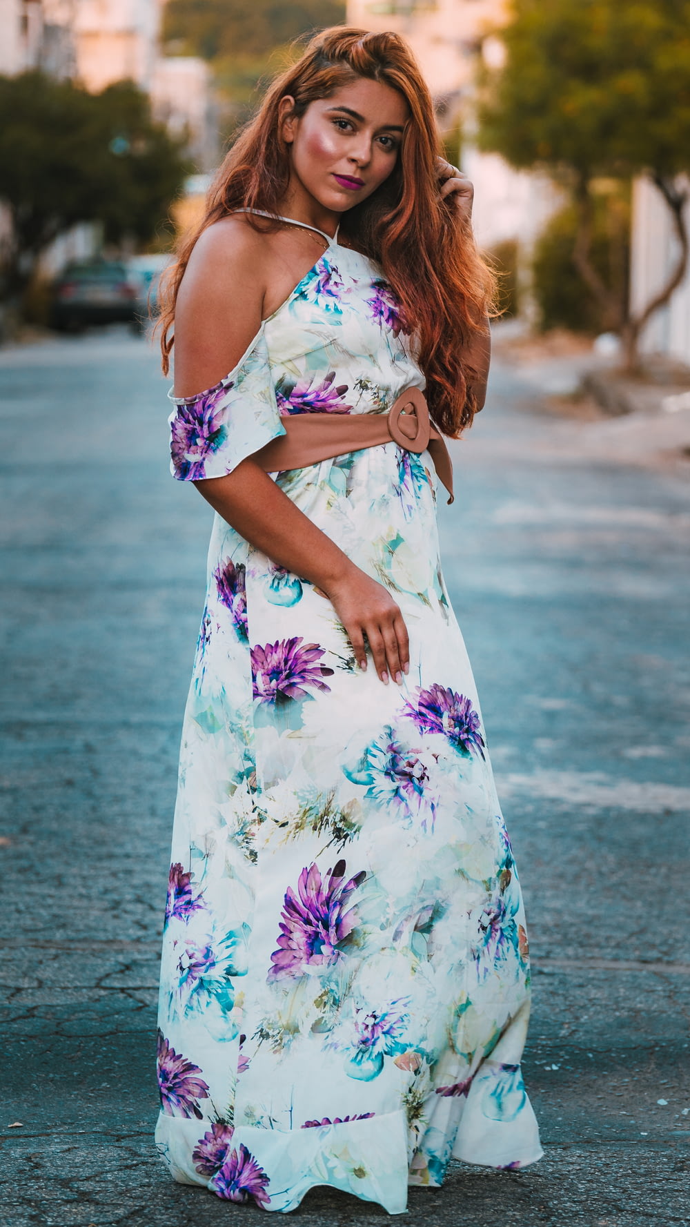 a woman in a floral dress posing for a picture