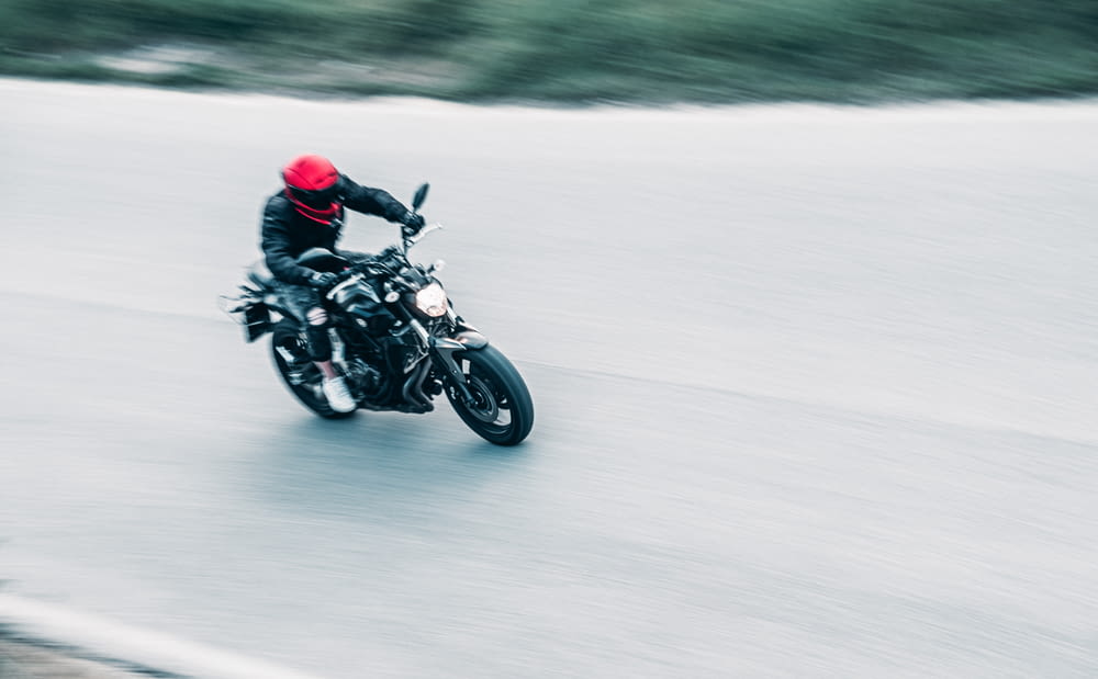 a man riding a motorcycle down a road