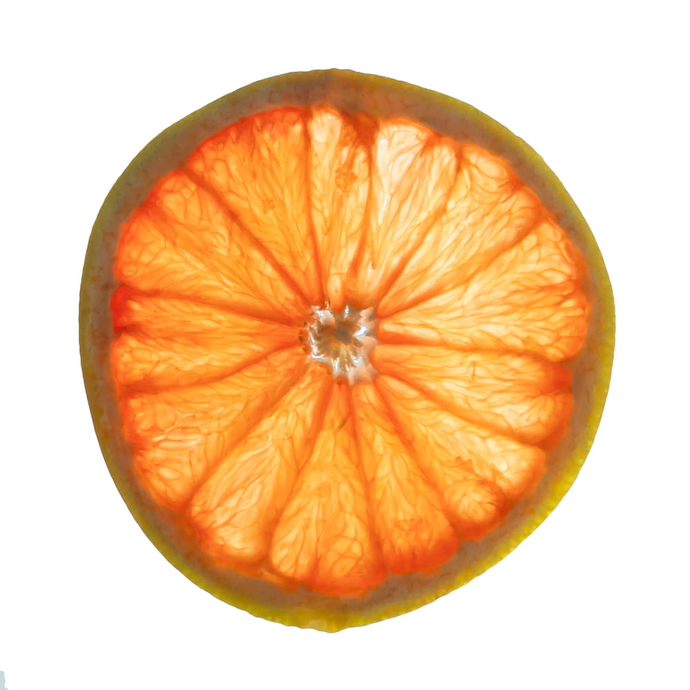 an orange cut in half on a white background