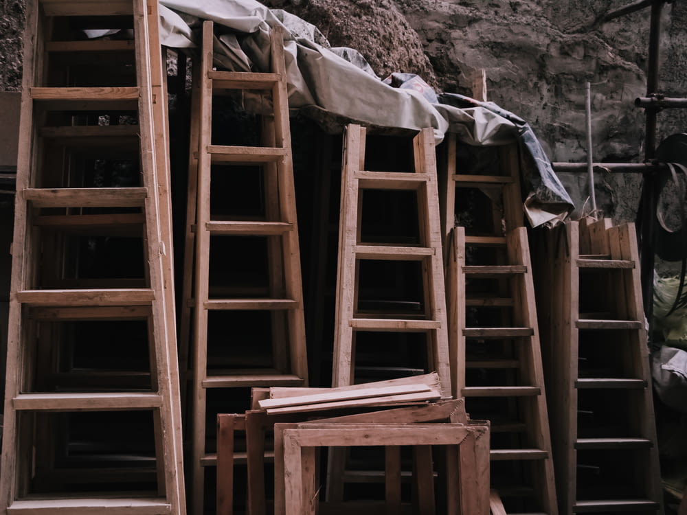 a pile of wooden ladders sitting next to each other
