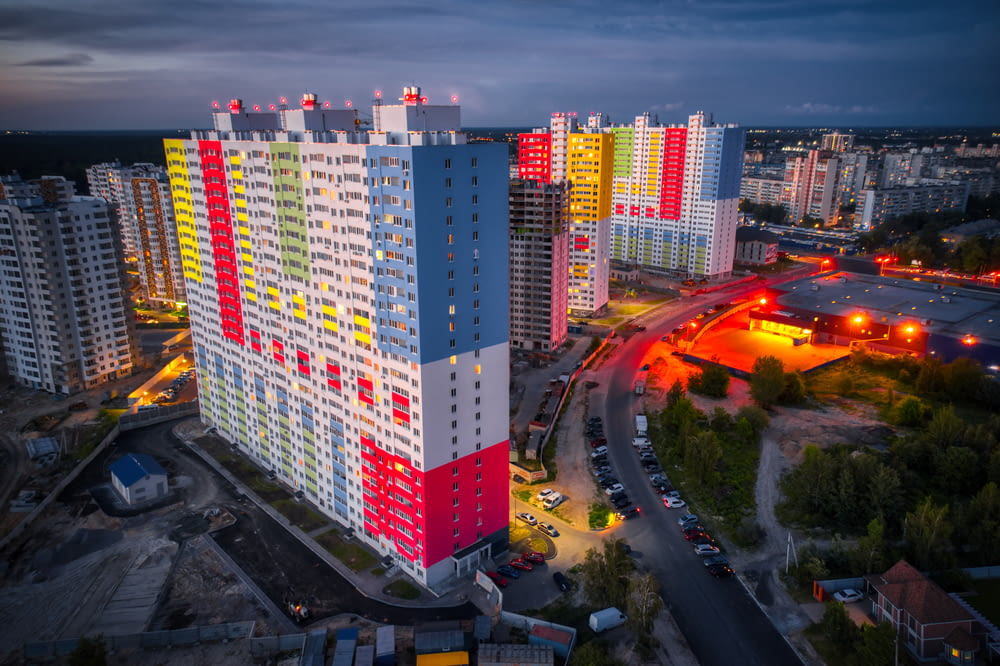 an aerial view of a multi - colored building in a city