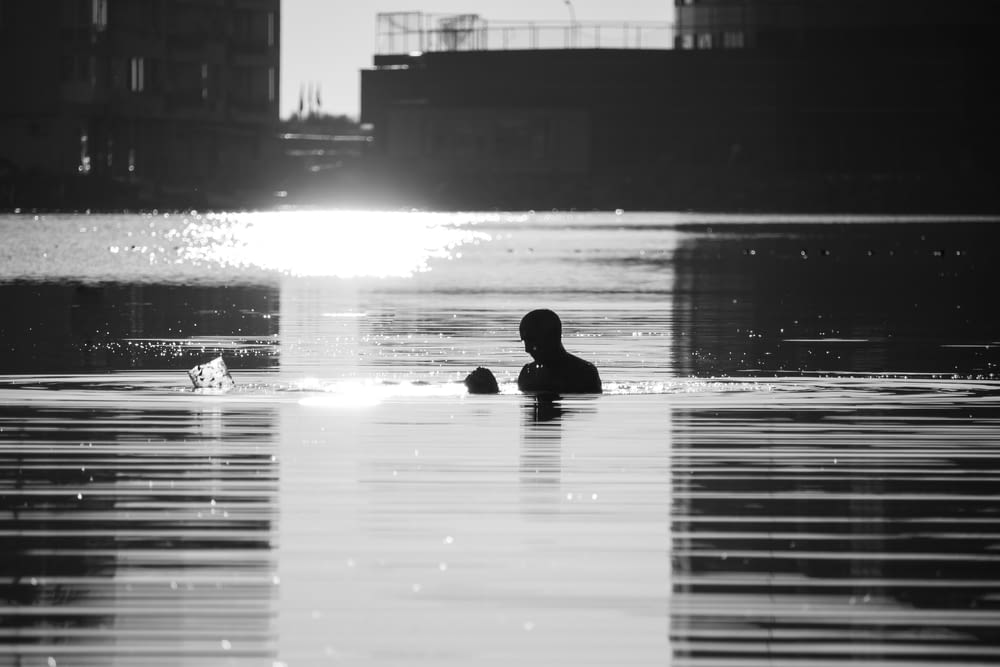 silhouette of person on water during daytime