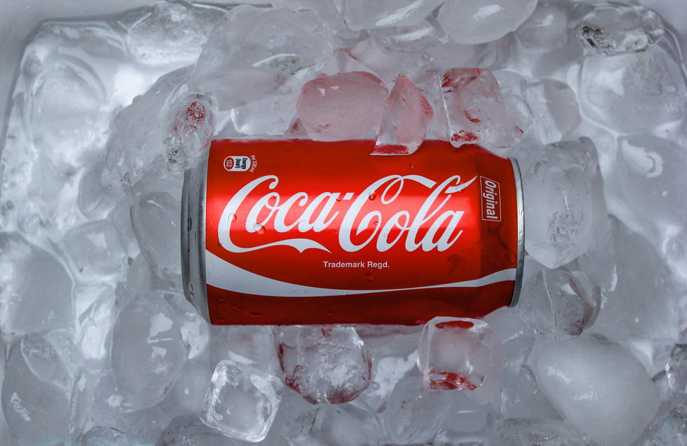 coca cola plastic bottle on white textile