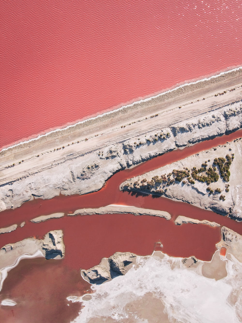 an aerial view of a body of water with red water