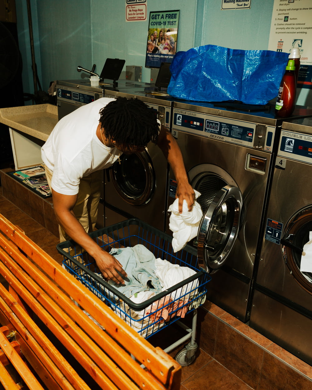 woman in white t-shirt washing dishes