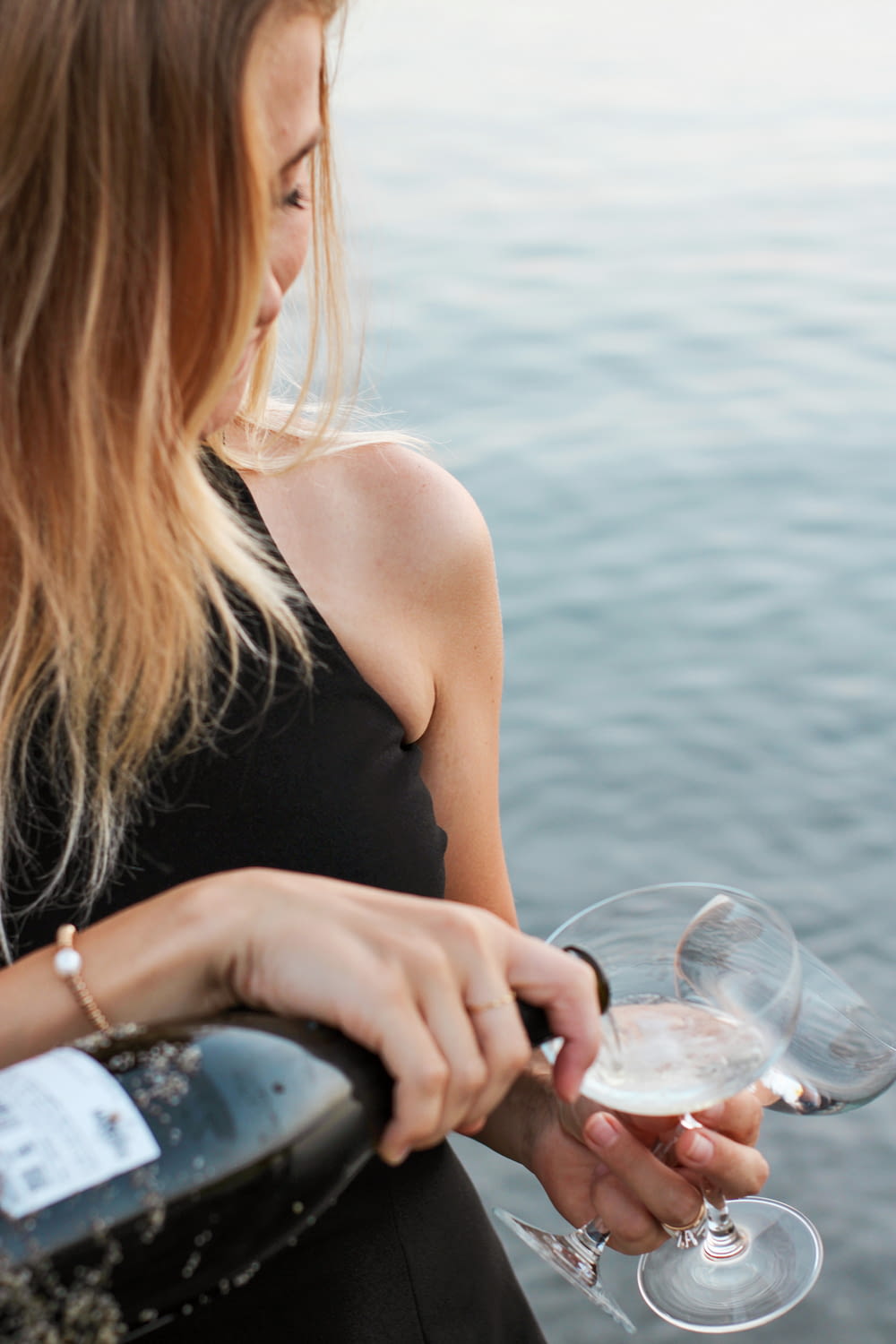 woman in black tank top holding wine glass