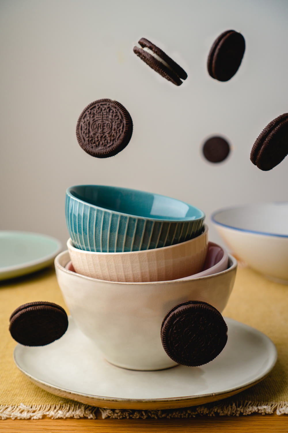 a table topped with plates and bowls filled with cookies