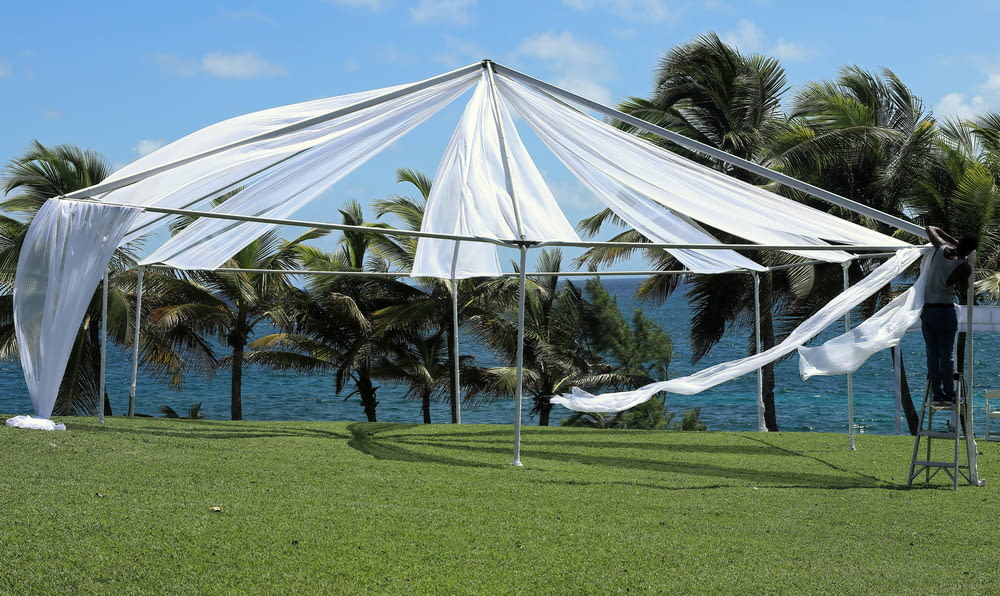white canopy tent on green grass field during daytime
