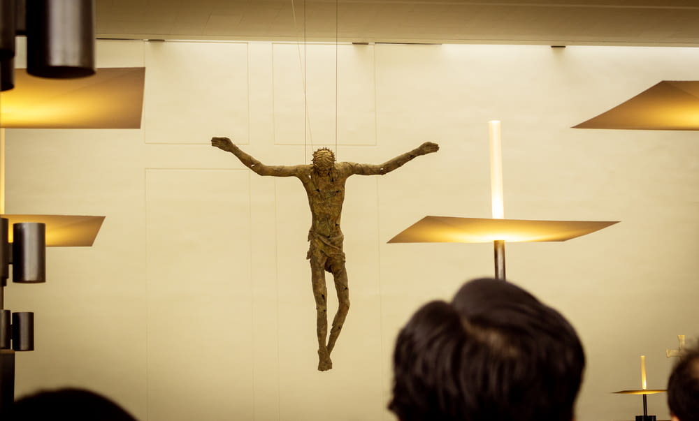 brown wooden crucifix on white wall