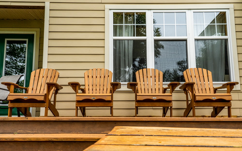 brown wooden chairs and table outside the house