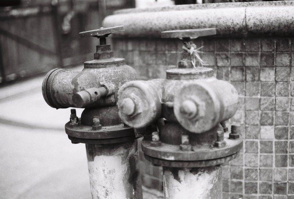 gray scale photo of water fountain