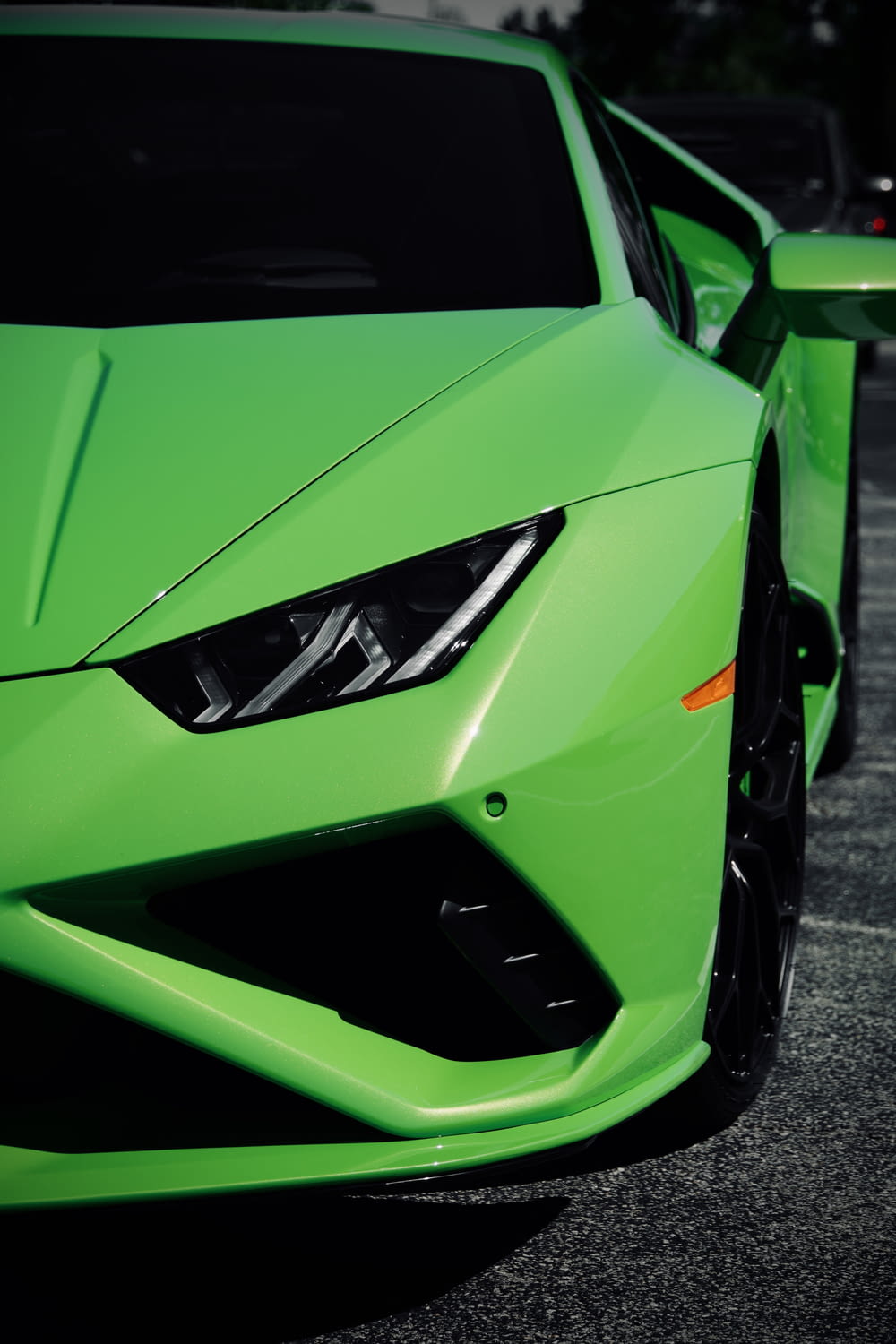 Grüner Lamborghini Aventador tagsüber auf grauer Asphaltstraße geparkt