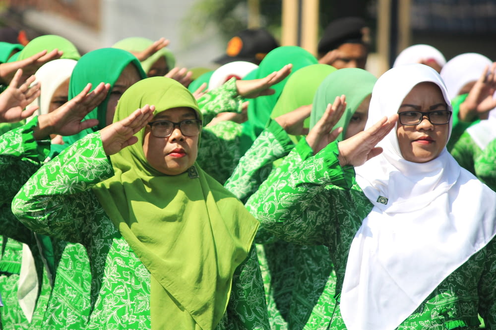 man in green hijab and white thobe