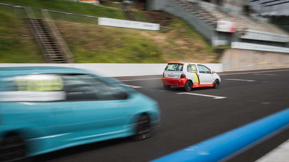 a small car driving down a race track