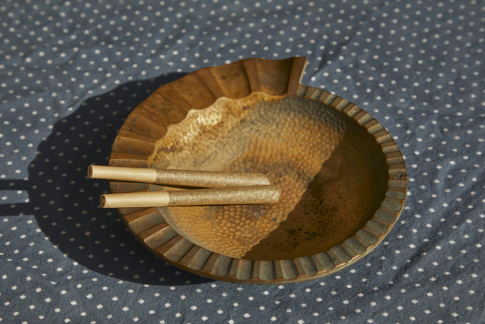 brown wooden round bowl with brown wooden sticks