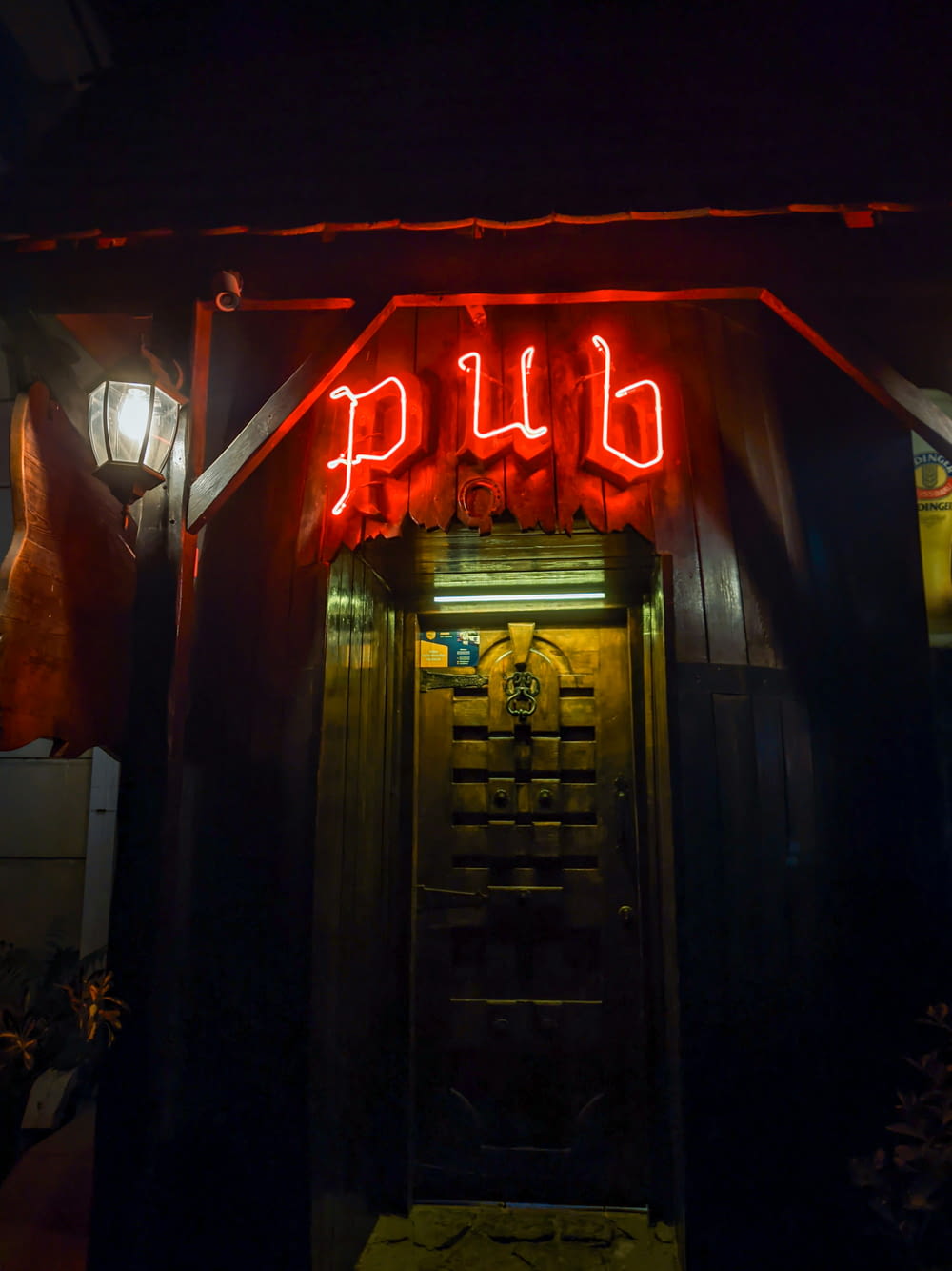 a red neon sign that reads pub above a doorway