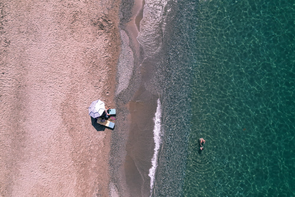 aerial view of white boat on sea shore during daytime
