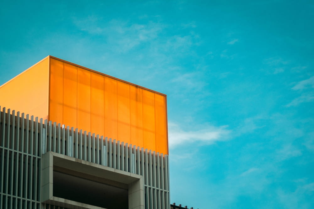 orange and white concrete building under blue sky during daytime