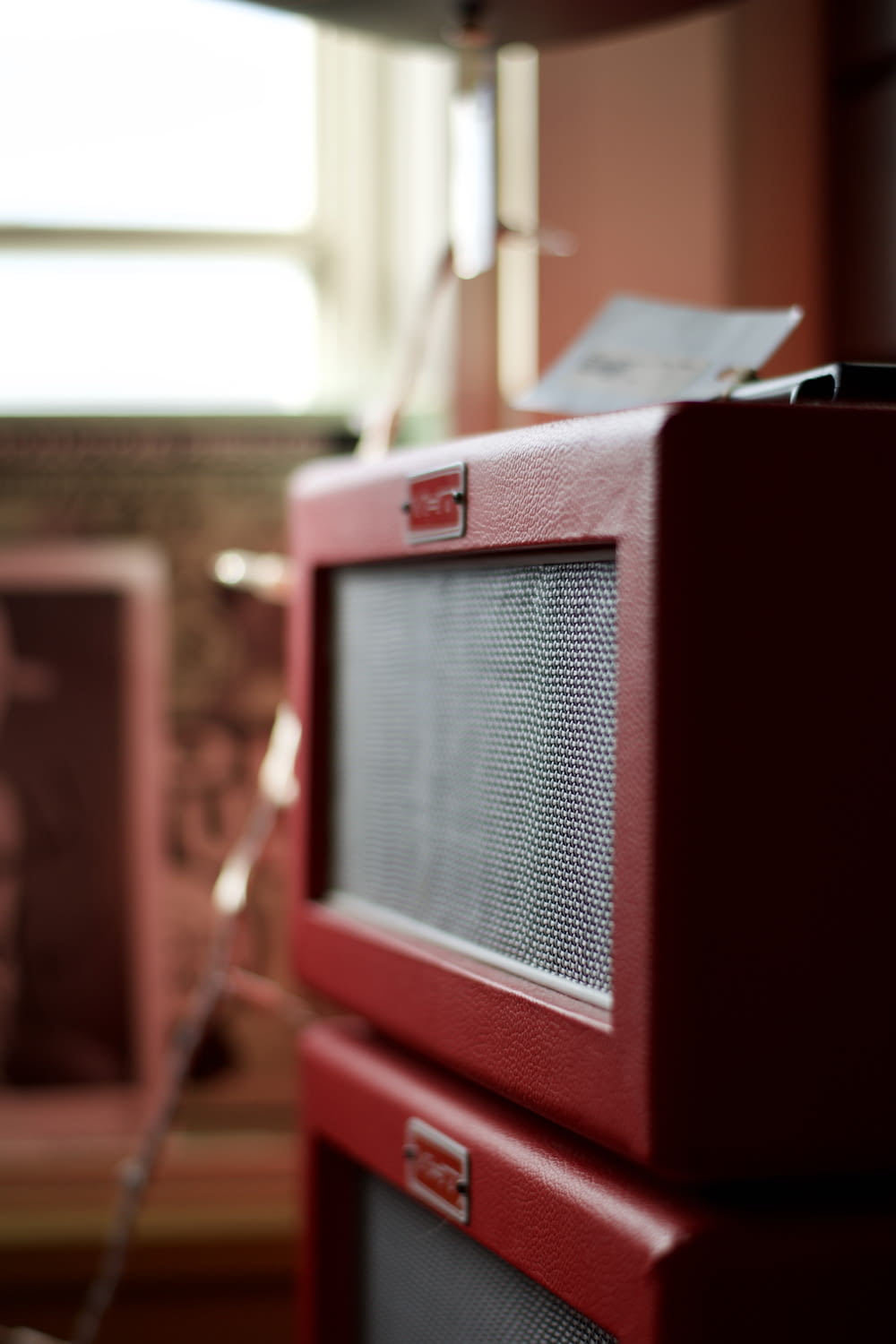 a red radio sitting on top of a wooden table