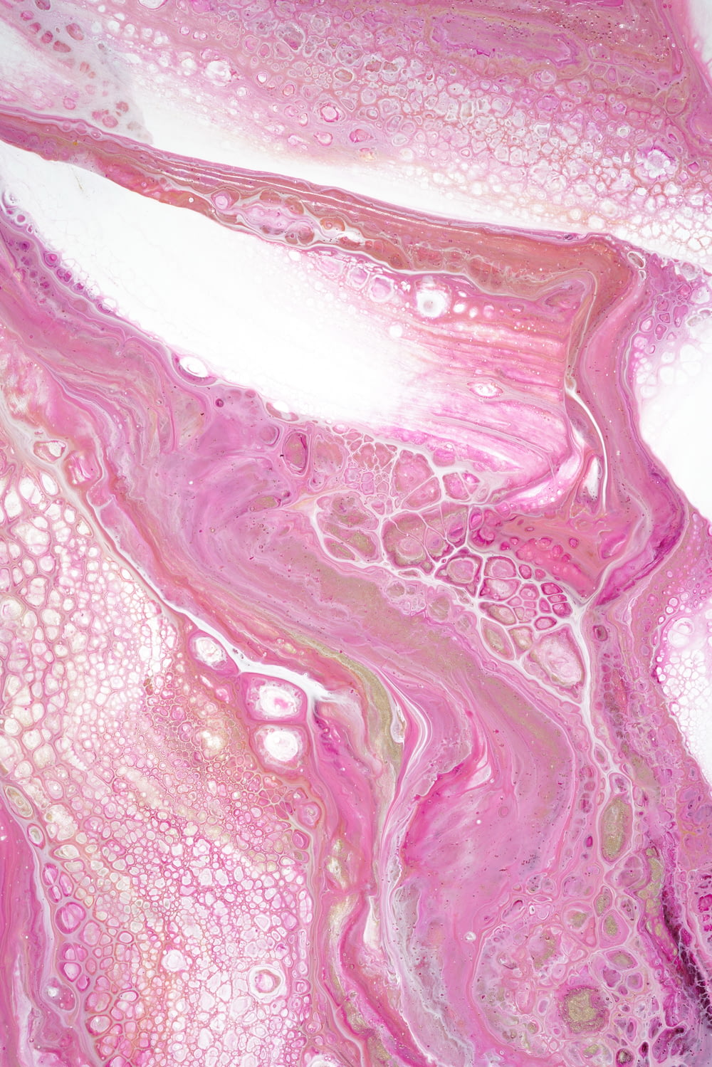 a close up of a pink and white fluid substance
